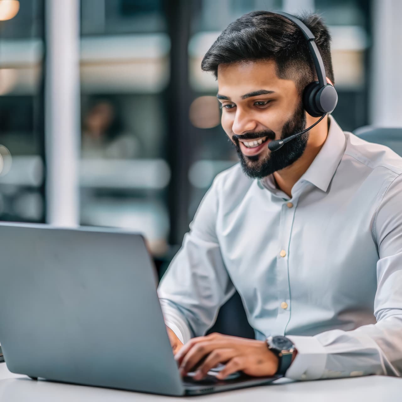 Male customer service employee smiling on headset