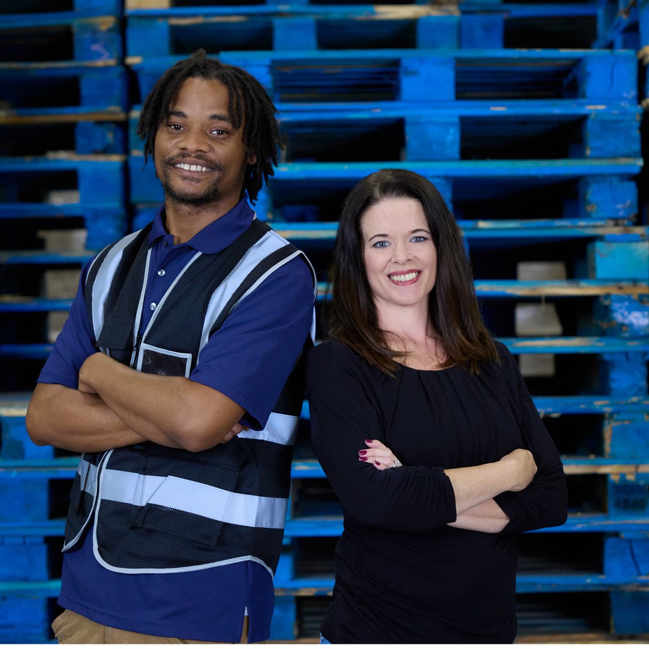 Man and woman posing in a warehouse