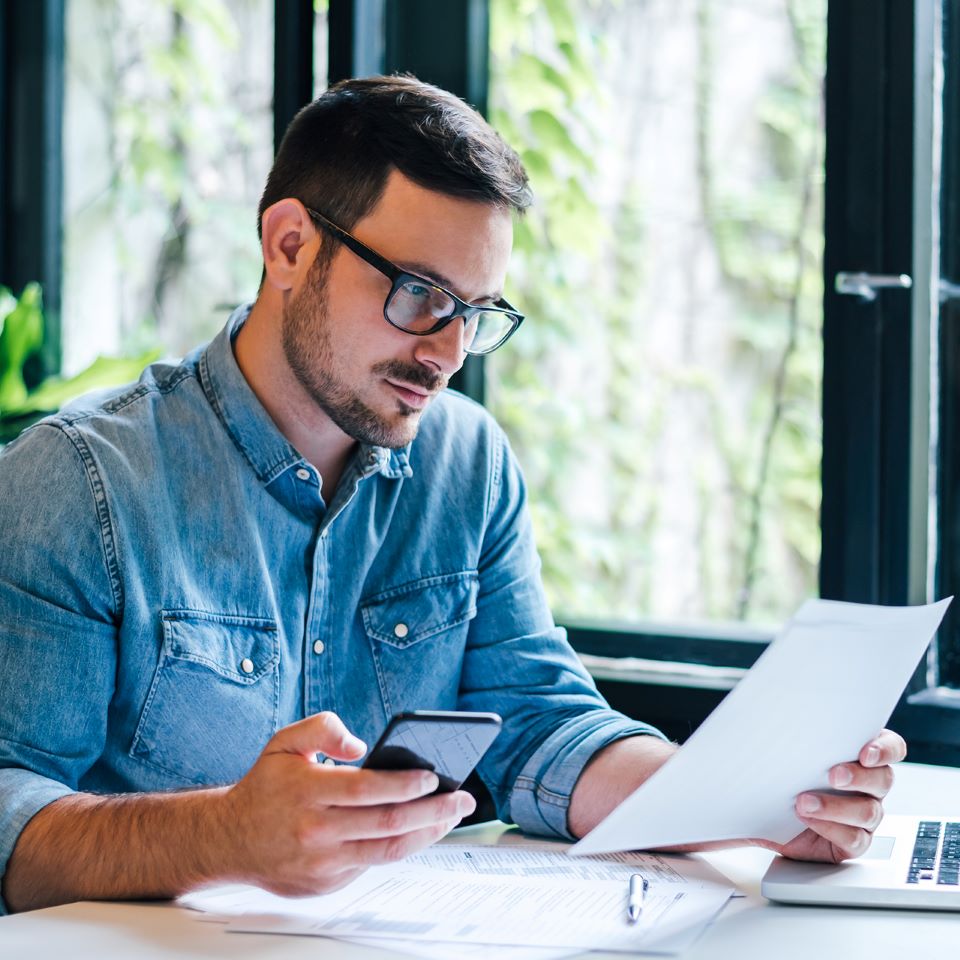 Account Manager working with pen and paper in an office