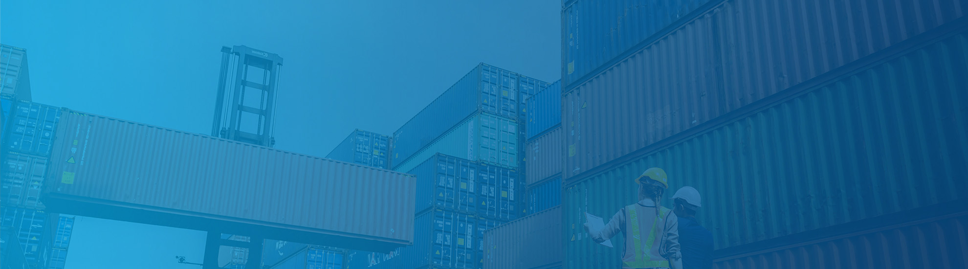 Two workers monitoring the shipping containers